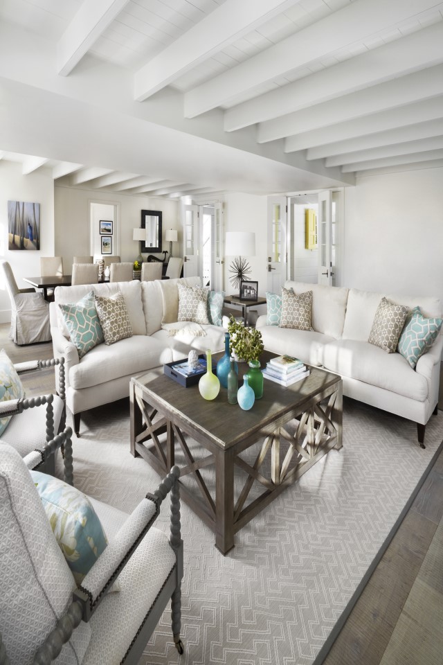 A gray area rug in a beach home adds a beautiful design element to any living space 