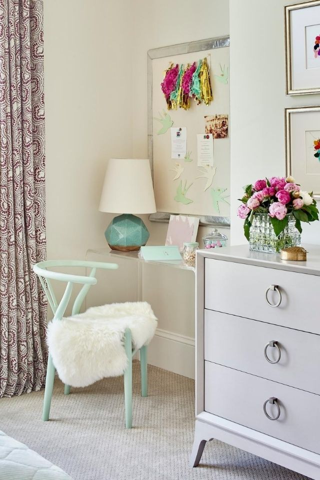 Clear kid's desk in bedroom with pinboard and fuzzy throw