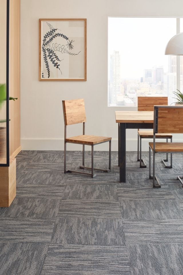 Commercial carpet tiles in patterned gray in office space 