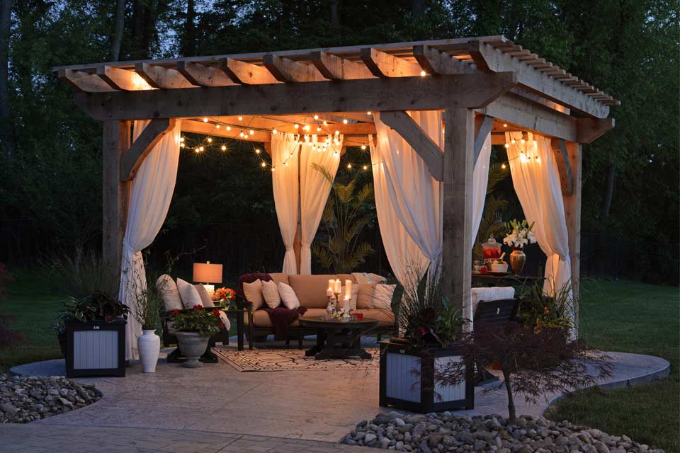 Outdoor patio with fairy lights and furniture in the evening