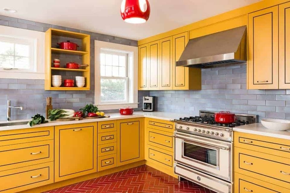 Bright yellow kitchen cabinets by Aline Architecture