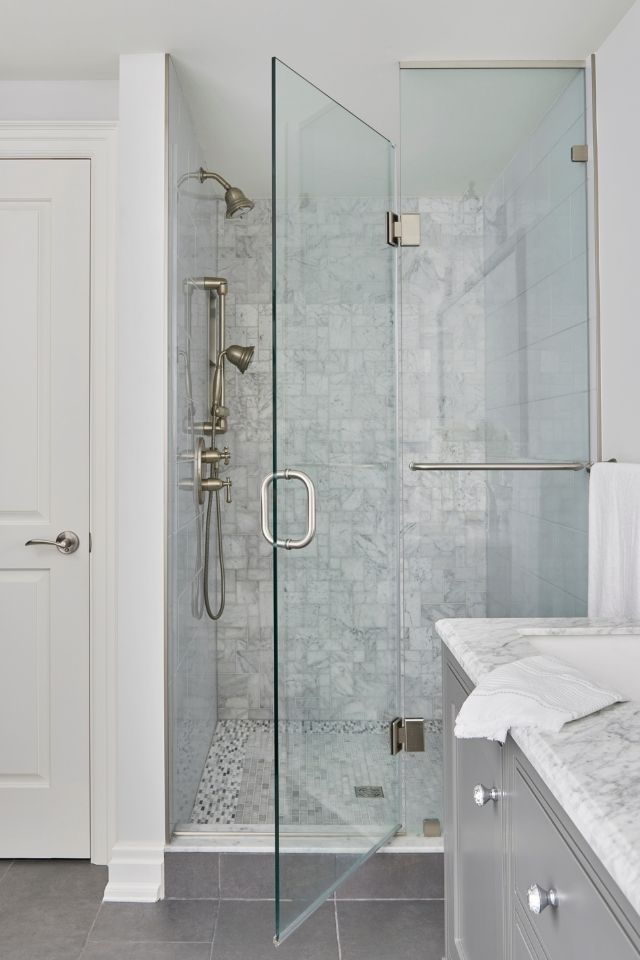 Glass surround walk in shower with gray tile 