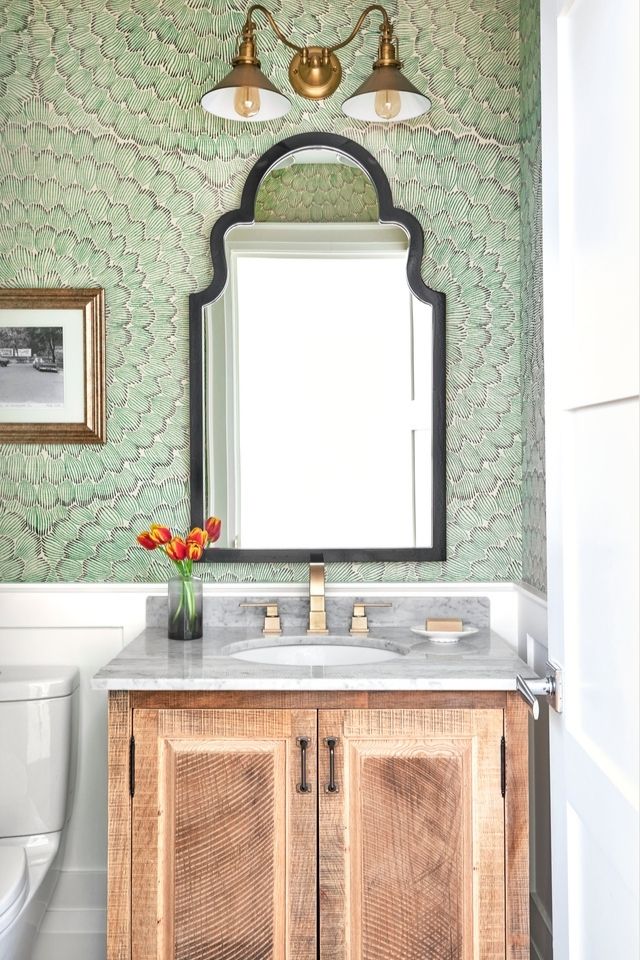Green wallpaper in bathroom behind wood vanity by Rebecca Hay 