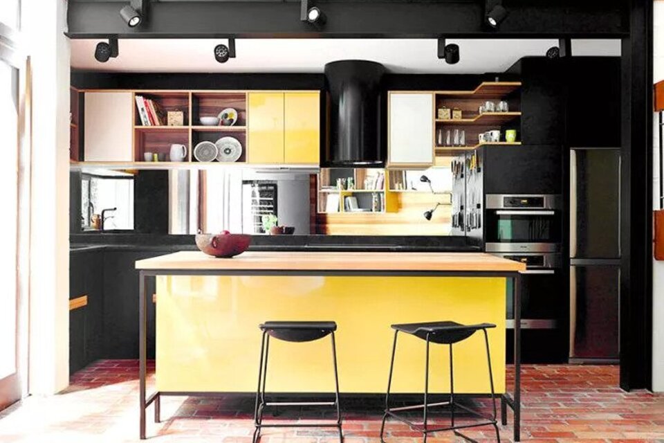 Yellow and black kitchen with island and black lighting fixtures
