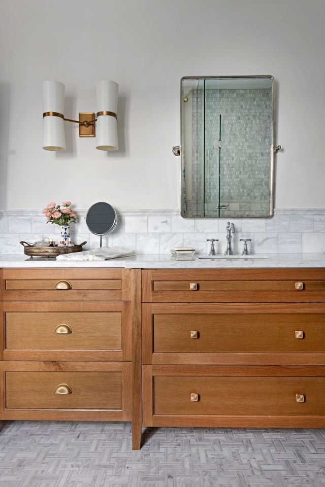 Natural wood vanity in white and gray bathroom with stone tile 