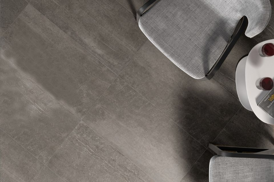 Gray emser tile on floor with clear chairs