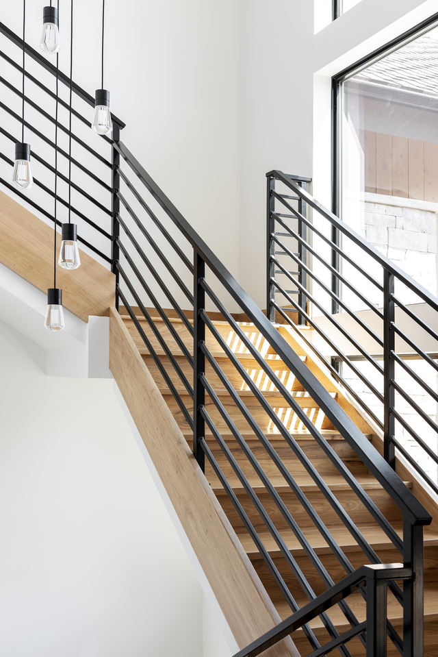 White oak staircase with black iron metal railing by Christa Pirl