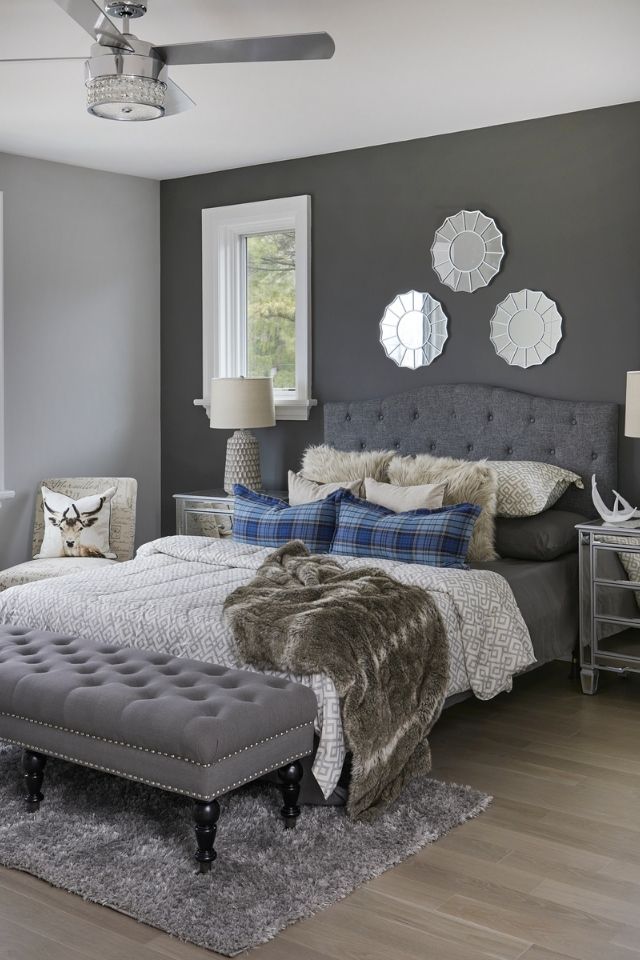 Dark gray accent wall in bedroom with varying shades of gray 