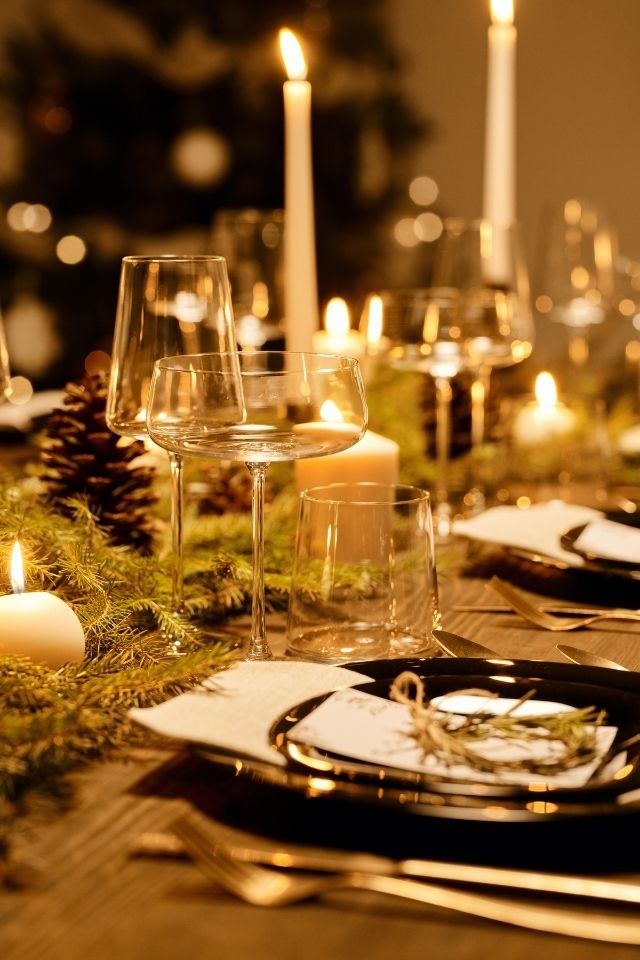 Delicately decorated dining table with varying glassware and candles