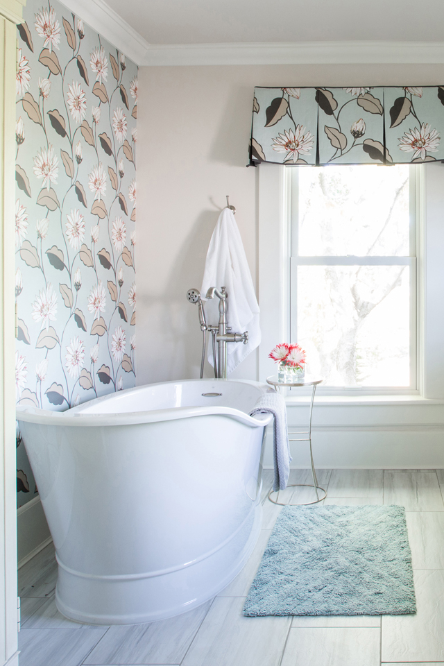 Fresh modern bathroom with floral wallpaper and soaking tub 