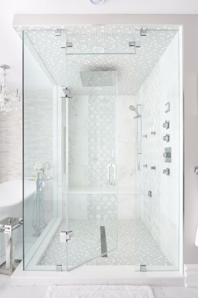 Gray and white walk in shower with tile and glass 
