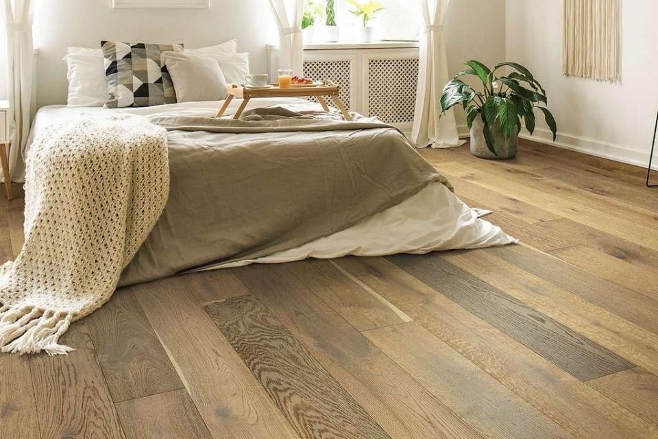 Natural wood flooring trending for 2022 in bedroom with neutral colors