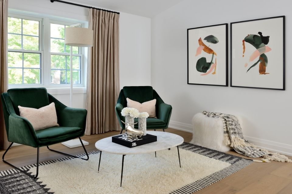 Emerald green chairs in living room with minimalist decor 