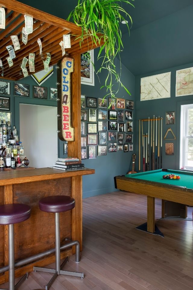 Man-cave with blue walls, built-in bar and pool table