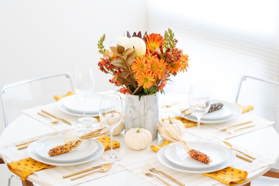 Fall-inspired holiday tablescape with flower centerpiece 