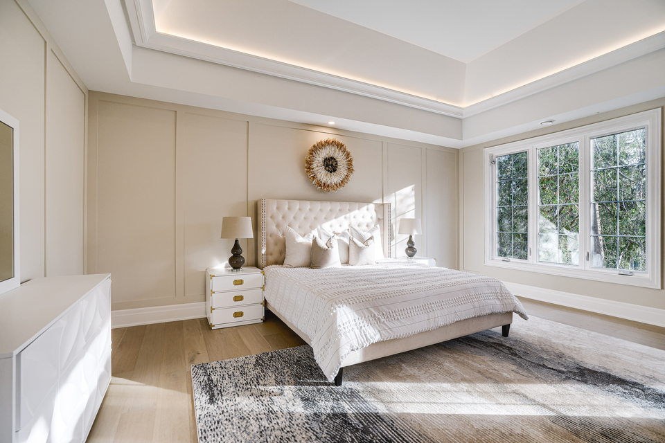 Bedroom designed by Diana Rose with large windows and shades of white