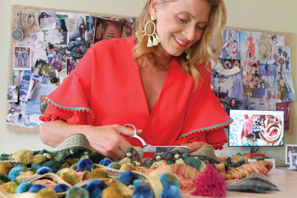 The Trim Queen, Jana Platina Phipps, cutting fabric in her studio