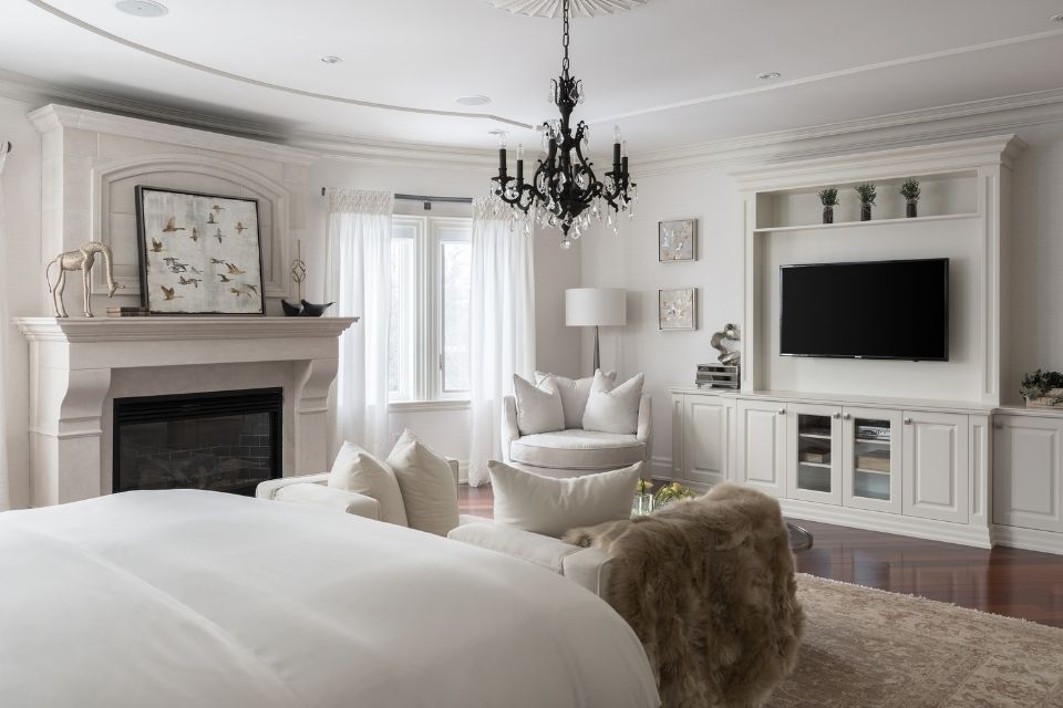 White bedroom designed by Diana Rose with fireplace