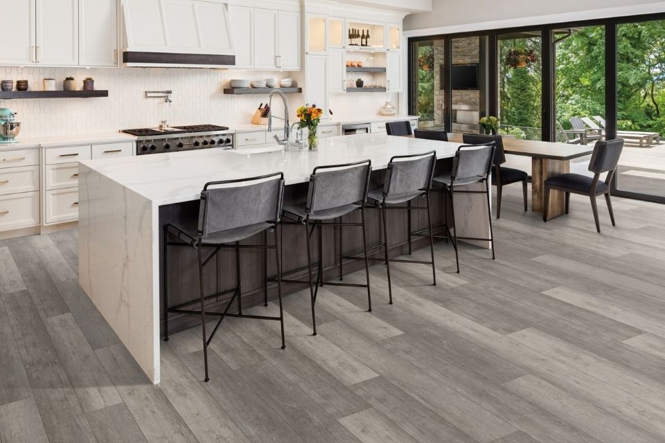 Gray toned waterproof wood look flooring in white kitchen 