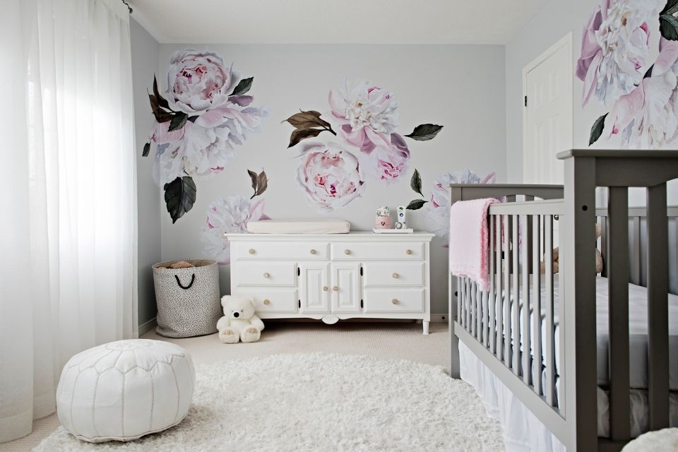 Girl's nursery room with flowers and wallpaper 