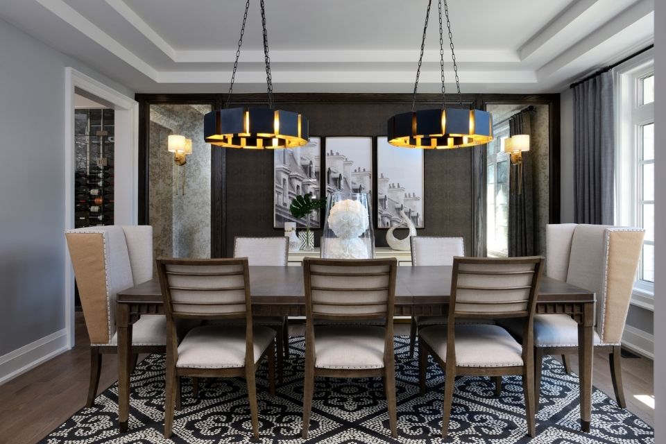 Dark dining room with large rectangular table and rectangular area rug