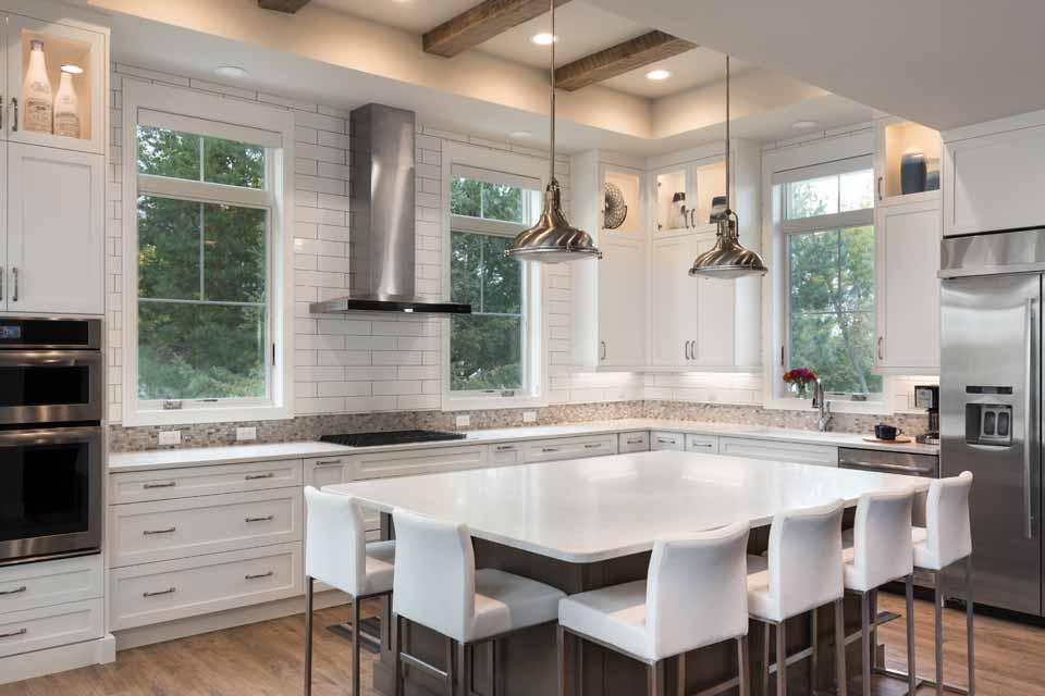 Timeless kitchen with white quartz countertops and stainless steel appliances