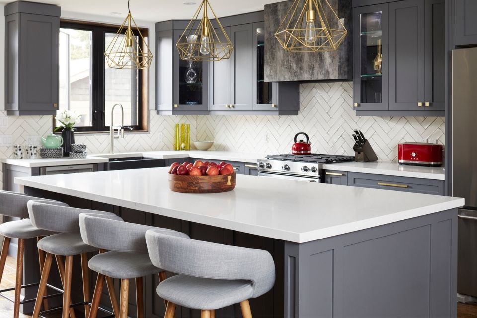 Dark gray cabinets in bright kitchen with white countertops 