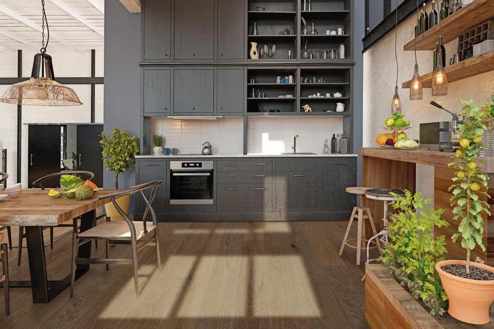 natural hardwood flooring in kitchen with grey cabinetry, open wood shelving, and greenery